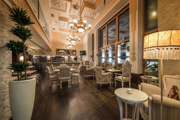 Modern restaurant with upholstered chairs and tables.